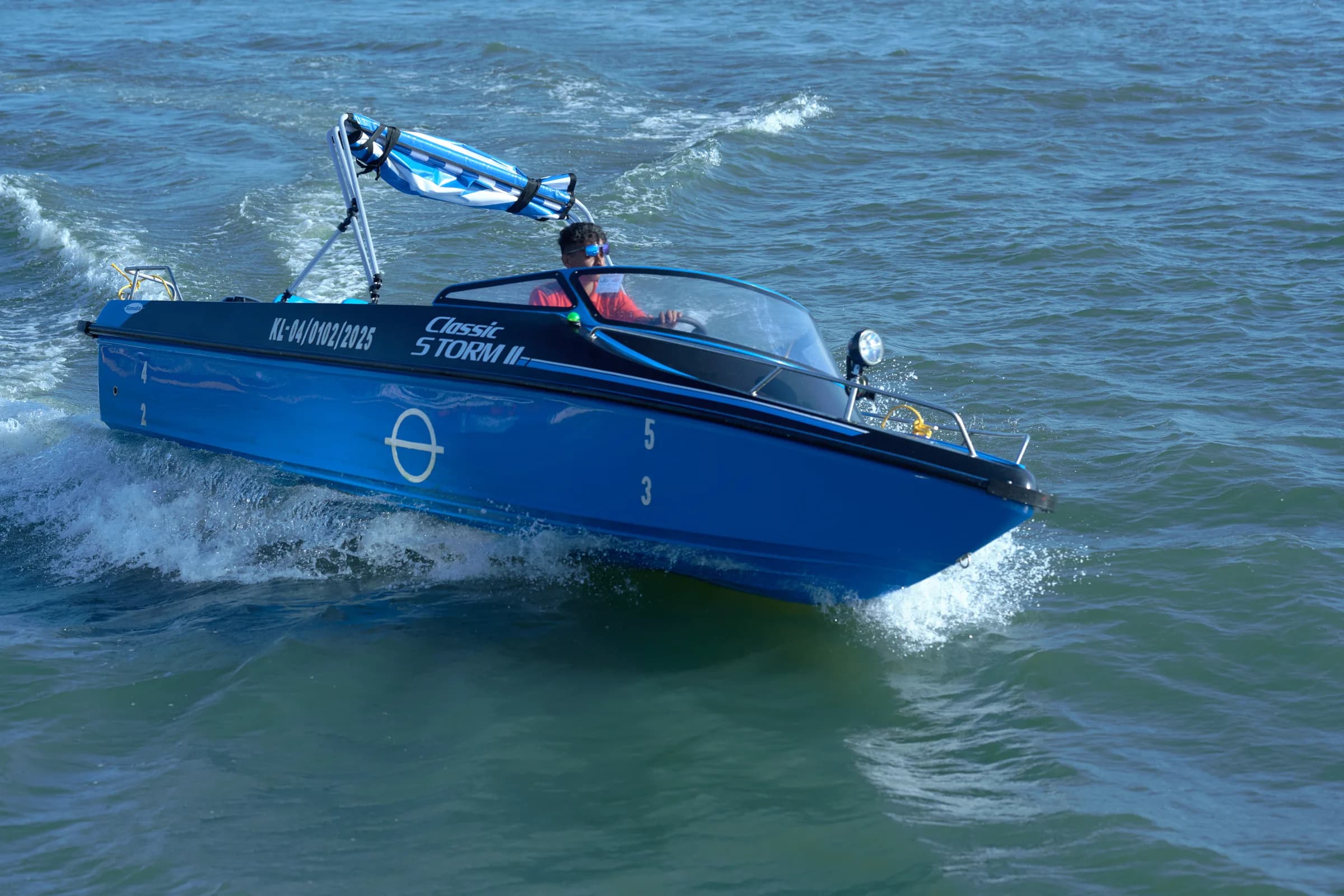 Classic Storm II speed boat splashing across the water